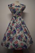 A 1940s unworn crisp cotton floral day dress with Royal label, having bright pattern, pleats to