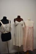A pale pink 1920s/30s slip, having scalloped edges, cutwork and embroidery, feels to be silk, a