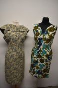 Two 1950s dresses, including late 50s metallic thread floral dress with shawl collar and floral bark