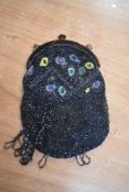 A 1920s/30s beaded bag, having tortoiseshell effect frame, void of strap, lining damaged.