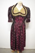 A late 1940s/ early 50s Dirndl style dress in burgundy, olive and leaf green, having pleated