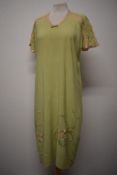 A handmade mint green 1930s nightdress, having extensive hand worked silk embroidered flowers to