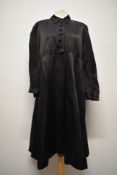 A 1920s/30s black silk or silk blend smock dress, having long sleeves with gathered cuff, pin