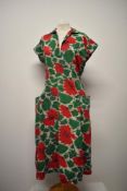 A bright and cheerful 1940s seersucker cotton day dress, with bold floral print, two pockets to