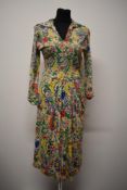 An incredible 1940s novelty print day dress in a floppy rayon/ jersey like fabric, having long