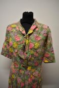 A colourful late 1950s cotton day dress, having pleated skirt and neckerchief style detail, larger