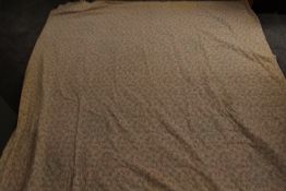 An early 20th century floral quilt with plain hand stitched reverse and machine stitched front,