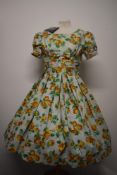 A 1950s unworn crisp cotton day dress with Shubette label, having bright floral pattern, pleated