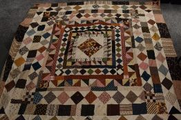 A late Georgian/ early Victorian patchwork bed covering, made up of colourful squares and