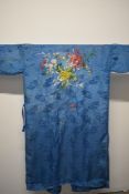 A 1930s kimono dressing gown, having embroidered floral spray in colourful silks to the reverse.