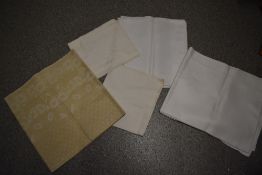 Five vintage and antique damask tablecloths.