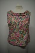 A late 1950s/ early 1960s brightly patterned top, with boat neckline and button accents and back
