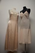 A 1930s pale pink bias cut full length nightdress, having intricate lace to bodice and hem, sold