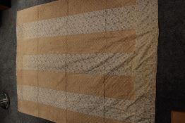 A Victorian strippy bed covering, made up of Beige fabric with white polka dots and floral fabric ,