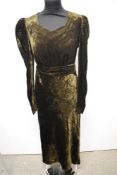 A 1930s dark olive green velvet bias cut evening gown, having long sleeves, sweetheart neckline
