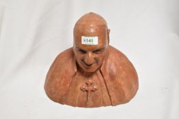 A well modelled terracotta/earthernware bust of a Catholic clergyman, with patinated finish.