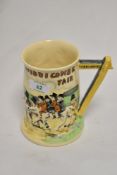 A Crown Devon 'Widdicombe Fair' relief moulded tankard, measuring 15cm tall