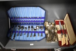 An assortment of loose cutlery and a partial canteen of plated cutlery.