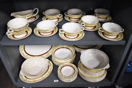 A collection of Midwinter tableware having white ground with cream and burgundy bands with gilt