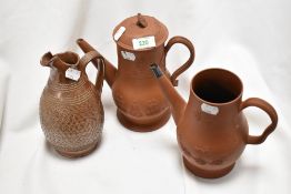 A 19th century embossed earthenware coffee pot with raised hunting scene, a similar styled teapot