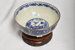 A 20th Century Chinese blue and white footed bowl, decorated with panels of figures and foliage,