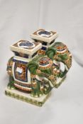 A pair of 20th glazed pottery plant or pot stands, in the form of Indian elephants, measuring 23cm