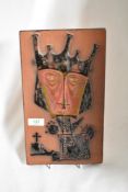 A mid century terracotta tile having abstract depiction of a king.