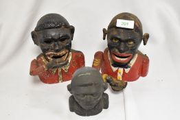 Three vintage cast metal articulated money boxes.