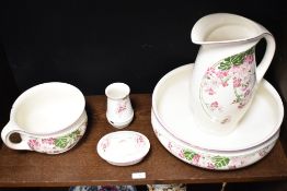 A Dutch Societe Ceramique Maestricht lustre wash jug and bowl, decorated with a floral spray