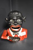 A vintage cast metal Jolly Gent mechanical money box.