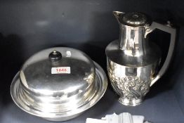 A silver plated coffee pot and a serving dish.