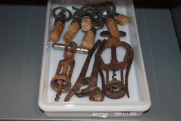 A collection of vintage cork and metal bottle stops, including Pheasant, Hare and stag and three
