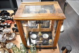 An early to mid 20th century wood and glass cased set of scientific scales.
