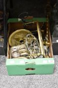 A selection of vintage brass trivets, a candlestick and similar flat ware.