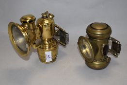 Two miniature brass metal car/ motorcycle carbide lamps, measuring 16cm tall
