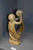 A natural stone group depicting a family of African origin.