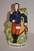 A reproduction Staffordshire pottery flatback Napoleon ornament, measuring 32cm tall