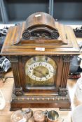 An early 20th century mahogany bracket clock, having beaded and carved detailing.