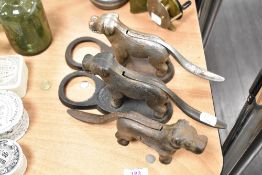 Three cast metal nutcrackers, in the form of dogs.