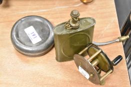 An early 20th century metal fishing reel and two oil cans.