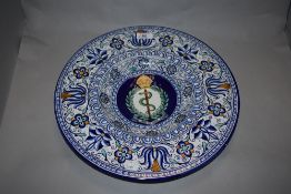 A continental charger, having Portuguese styling, with serpent, crown and wreath to centre and