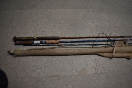 2 vintage fishing rods and a rod quiver containing rod pieces one of the rods is a split cane 3pc