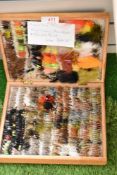 A wooden box containing approximately 600 hand tied flys and Lures doubles and winged trout