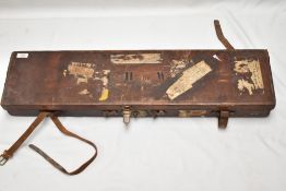 A Leather gun case measuring 82cm x 20cm x 8cm bearing the initials C H De W and internal labels