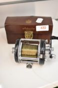 An ABU Ambassadeur 6000c fishing reel in leather case