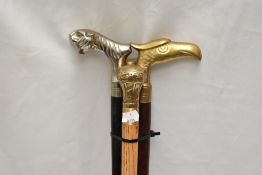 Four walking sticks with brass or metal handles one has an Eagles head one a Tigers head and one