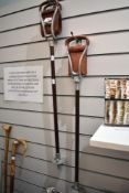 Two shooting sticks with fold out leather seats