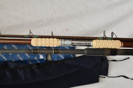 A Daiwa carbon 2pc whisker rod and an unmarked 2pc surf rod both in soft cases