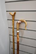 A shepherds crook and thumb stick measuring 120cm and 124cm respectively