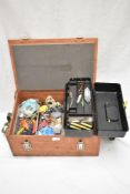 A wooden clip top box containing a selection of sea fishing tackle including lures hooks and